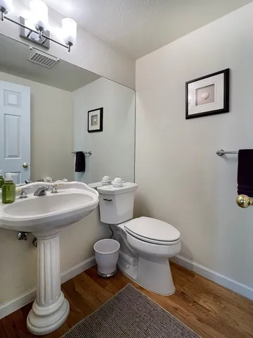 a bathroom with a sink toilet and a mirror