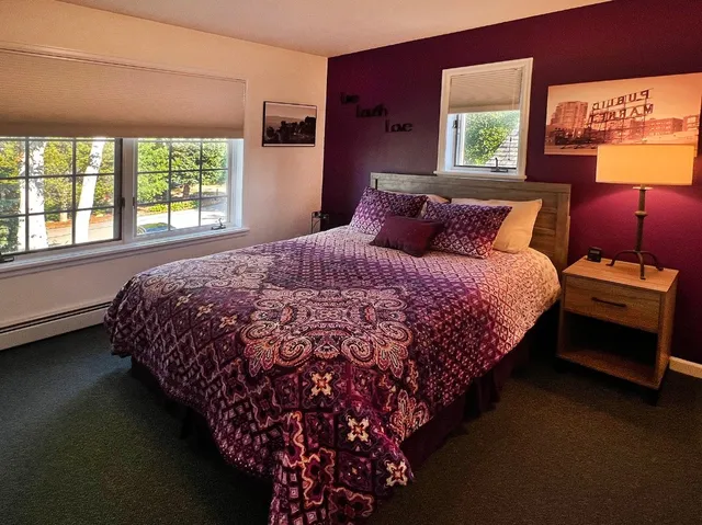 a bed sitting in a bedroom next to a window