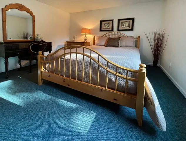 a view of a bedroom with furniture