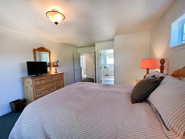 a bedroom with a bed and a television