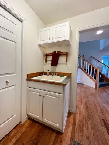 a kitchen with kitchen island a stove and wooden floor