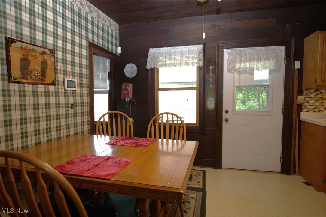 22760 Roy Croy Road Senecaville, OH 43780 - Photo 5 of 46 Dining room featuring light flooring, wooden ceiling, and wallpapered walls