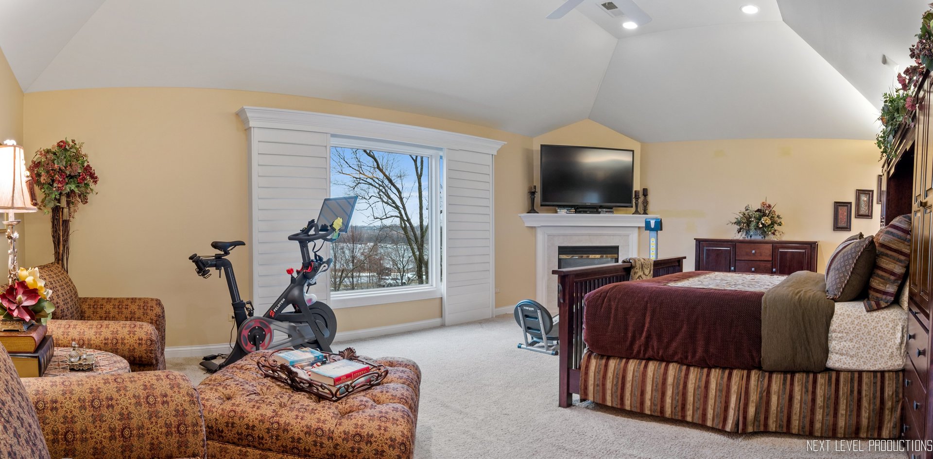 1787 Rizzi Lane Bartlett, IL 60103 - Photo 18 of 47 a living room with furniture a flat screen tv and a floor to ceiling window