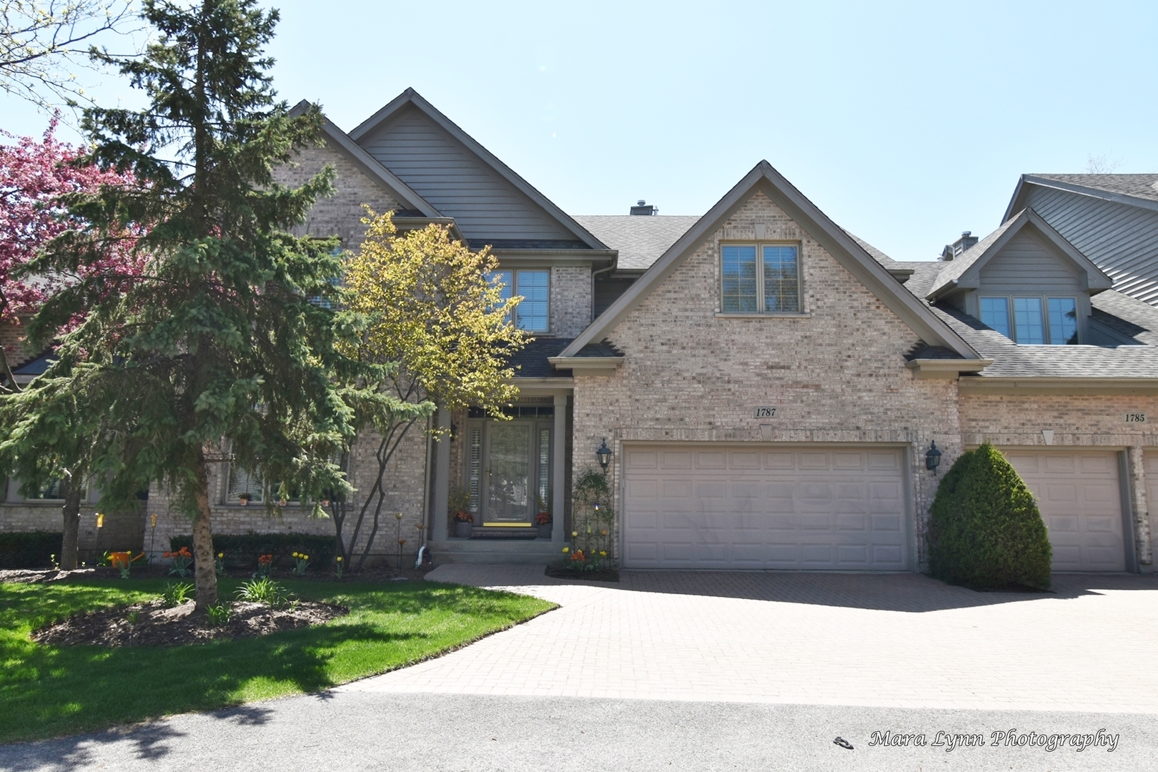 1787 Rizzi Lane Bartlett, IL 60103 - Photo 2 of 47 a front view of a house with a garden and trees