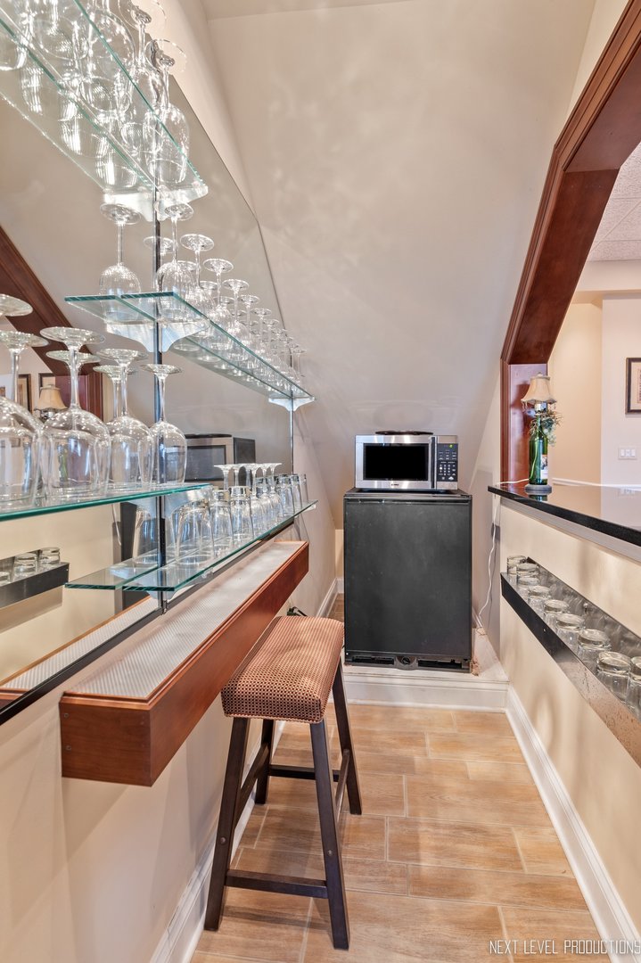 1787 Rizzi Lane Bartlett, IL 60103 - Photo 34 of 47 a kitchen with stainless steel appliances granite countertop a stove and a microwave