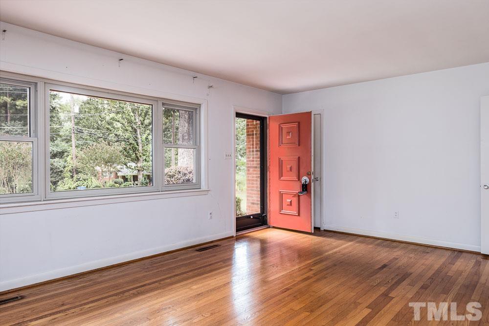 602 Wofford Road Durham, NC 27707 - Photo 9 of 26 Dramatic fireplace that separates this cozy room from the kitchen.