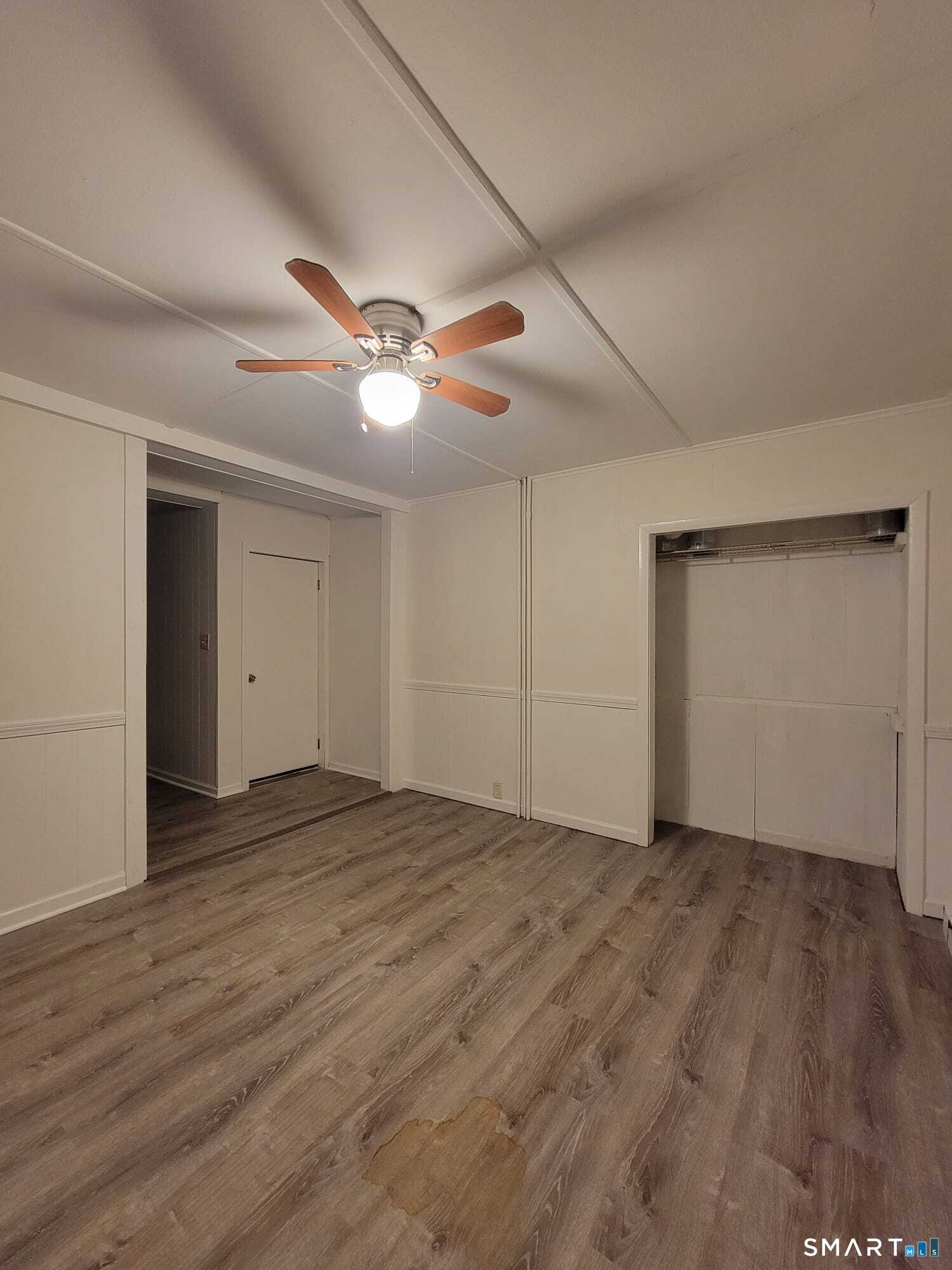 219 Pleasant Street, Unit 1B Windham, CT 06226 - Photo 1 of 1 an empty room with wooden floor and windows