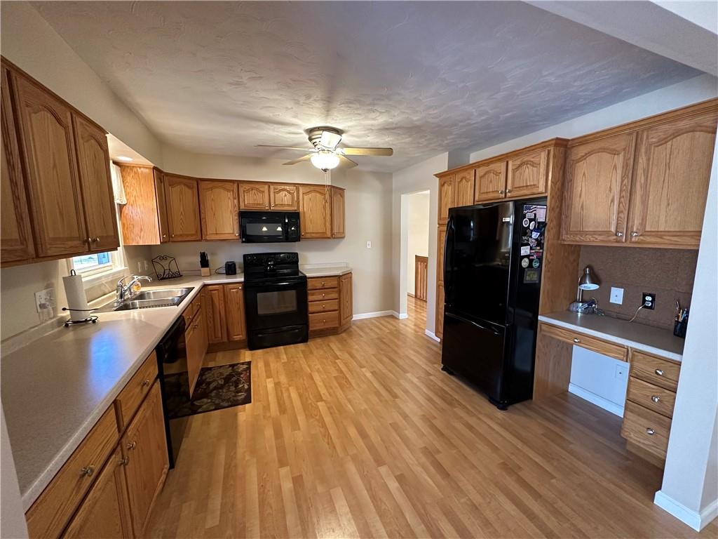 3048 Warren Road Indiana, PA 15701 - Photo 3 of 11 a kitchen with granite countertop a refrigerator stove top oven and sink