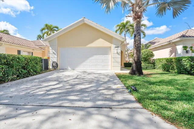 a front view of a house with a yard and a garage