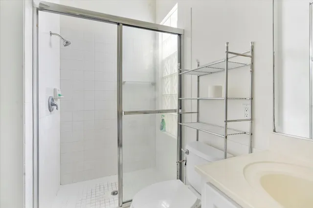 a bathroom with a sink toilet and shower