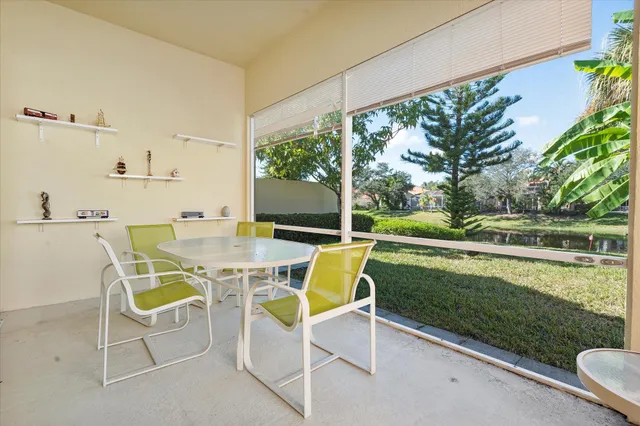 a dining room with furniture a large window and kitchen view