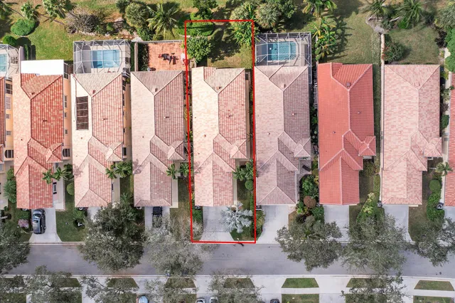 an aerial view of house with yard and lake view