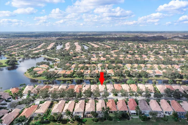 an aerial view of a houses with outdoor space and lake view