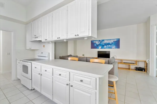 a kitchen with white cabinets and white appliances