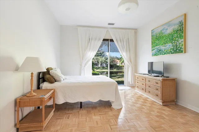 a spacious bedroom with a bed and large windows