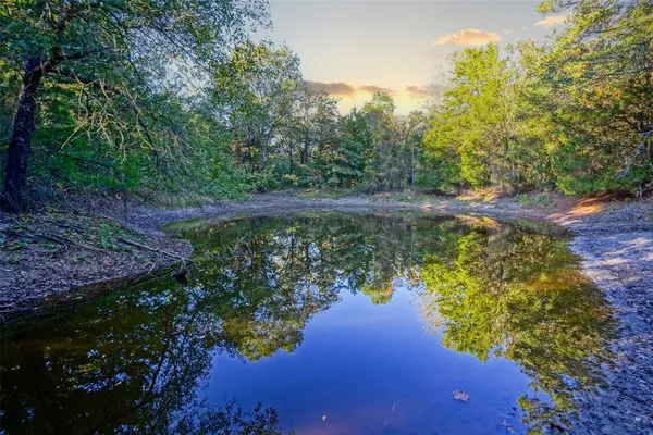 a view of a lake with a house in the background