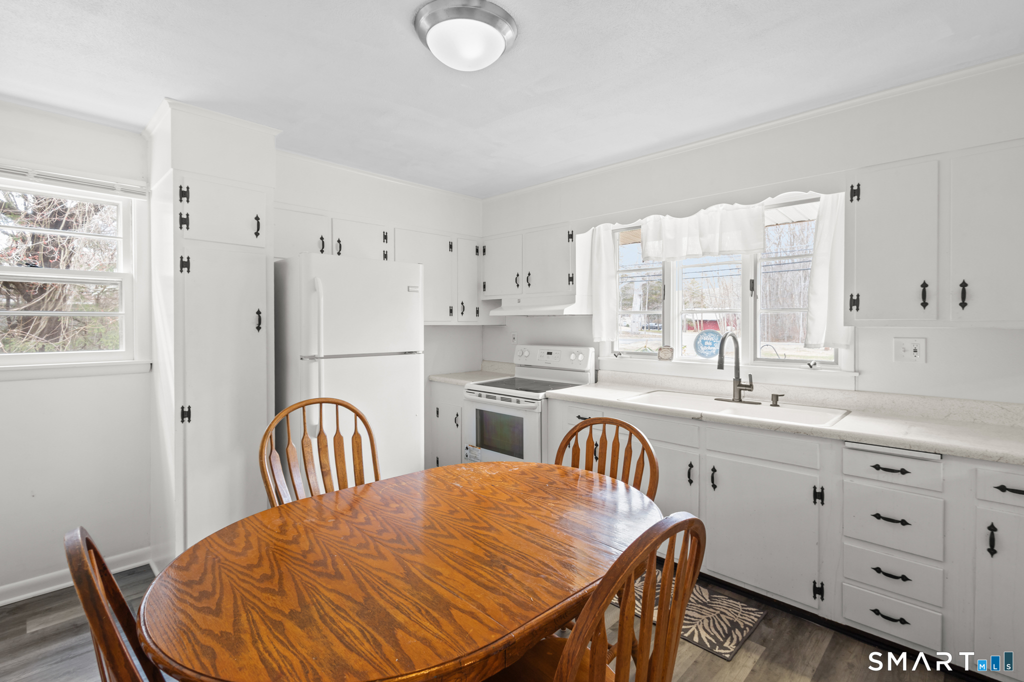 226 Beaumont Highway Lebanon, CT 06249 - Photo 11 of 43 a kitchen with stainless steel appliances granite countertop a sink a stove a dining table and chairs