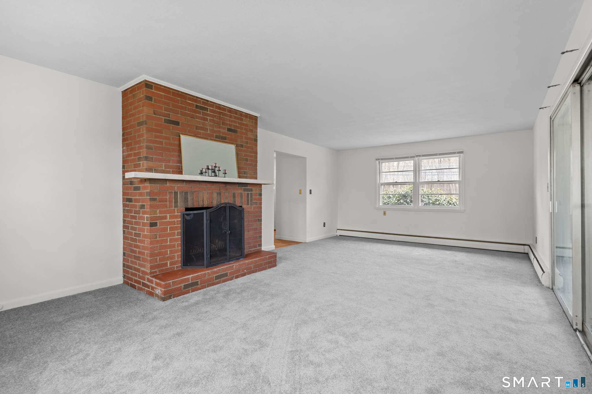 226 Beaumont Highway Lebanon, CT 06249 - Photo 18 of 43 a view of an empty room with a fireplace and a window