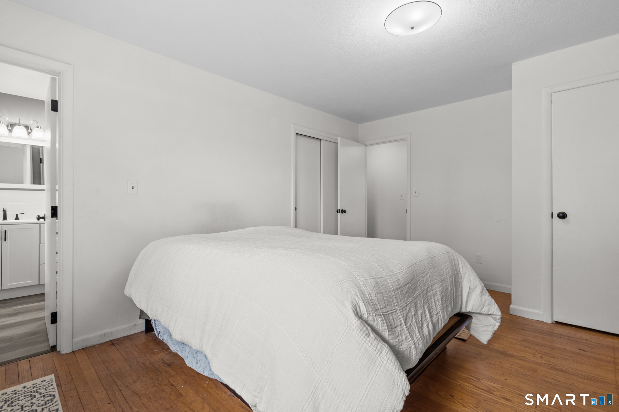 226 Beaumont Highway Lebanon, CT 06249 - Photo 29 of 43 a bedroom with a bed and a night stand