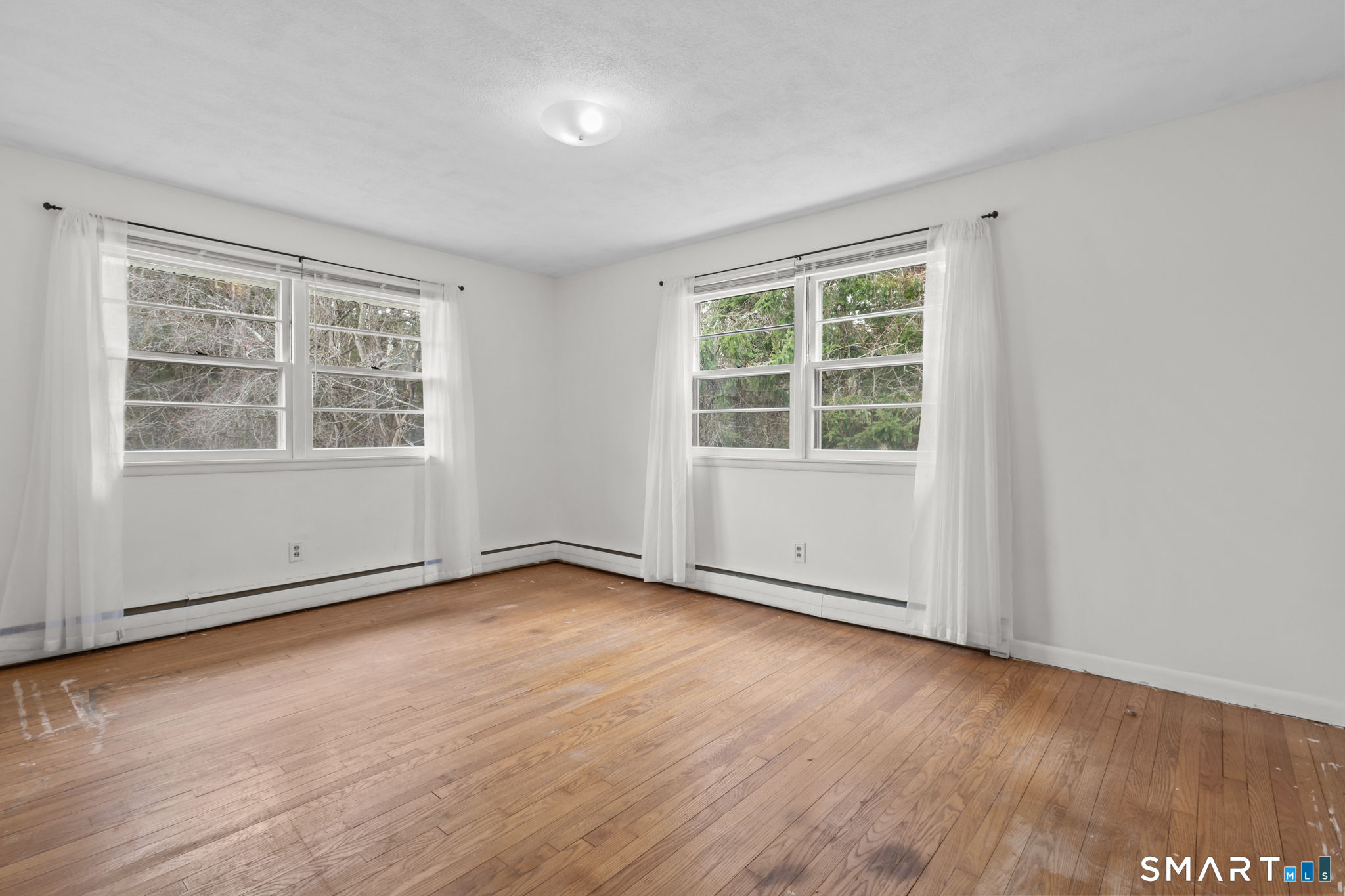226 Beaumont Highway Lebanon, CT 06249 - Photo 31 of 43 an empty room with wooden floor and windows
