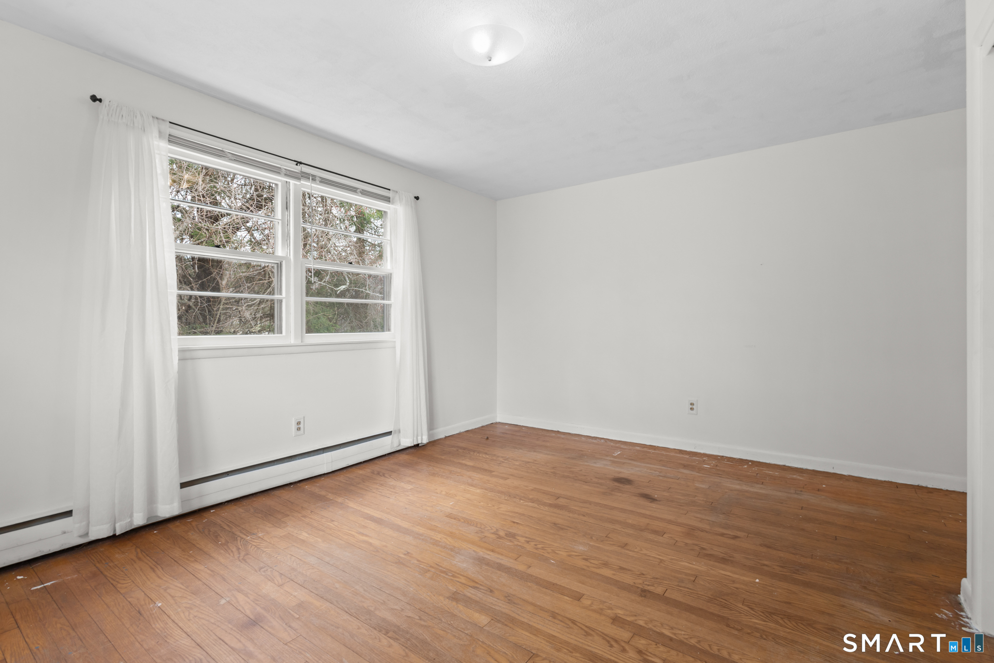 226 Beaumont Highway Lebanon, CT 06249 - Photo 34 of 43 an empty room with wooden floor and windows