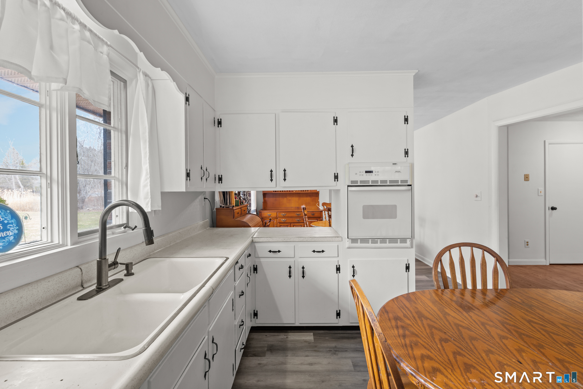 226 Beaumont Highway Lebanon, CT 06249 - Photo 9 of 43 a kitchen with stainless steel appliances a sink a stove a table cabinets and a dining table