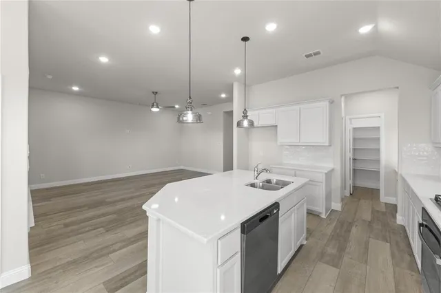 a kitchen with a sink stove and refrigerator