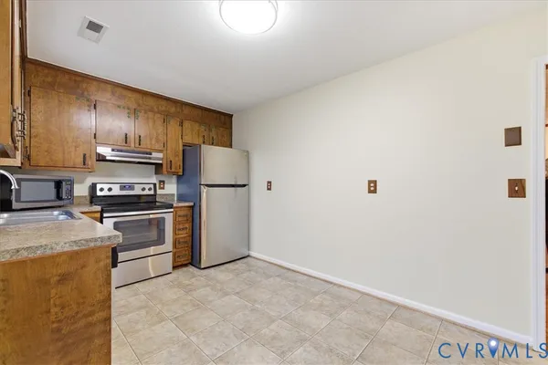 a utility room with cabinets washer and dryer
