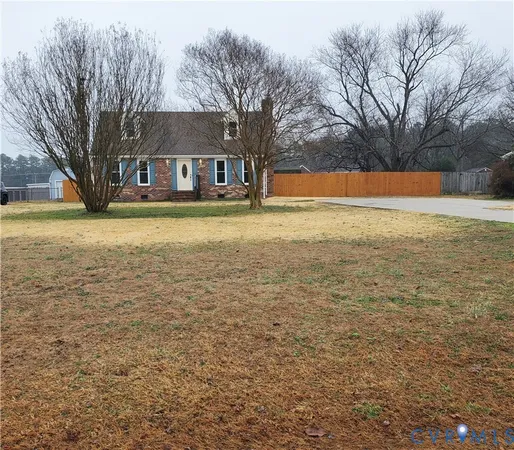 a front view of house with yard and trees