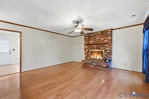 a living room with a fireplace and a wooden floor