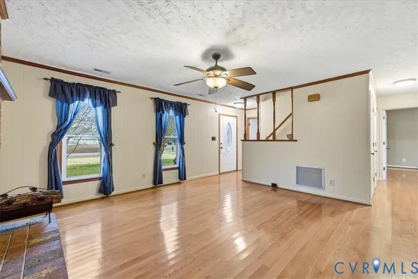 a kitchen with refrigerator cabinets and wooden floor