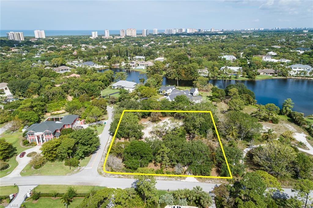 151 Caribbean Road Naples, FL 34108 - Photo 2 of 7 an aerial view of residential houses with outdoor space and swimming pool
