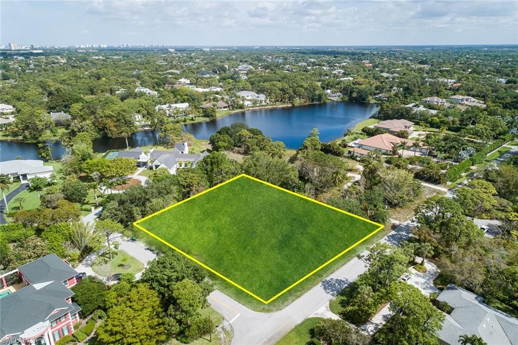 151 Caribbean Road Naples, FL 34108 - Photo 3 of 7 an aerial view of a residential houses with outdoor space and lake view