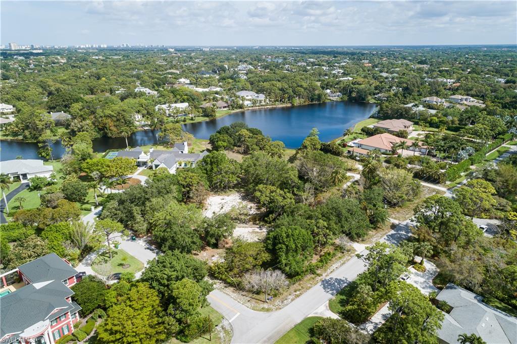 151 Caribbean Road Naples, FL 34108 - Photo 6 of 7 an aerial view of residential houses with outdoor space and lake view