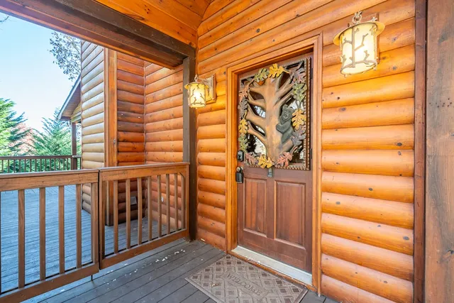 a view of backyard with wooden fence and large trees