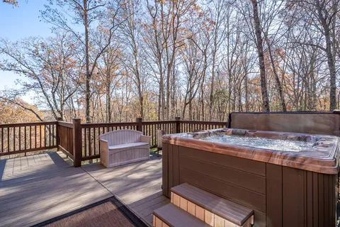 a living room with fireplace furniture and a large window