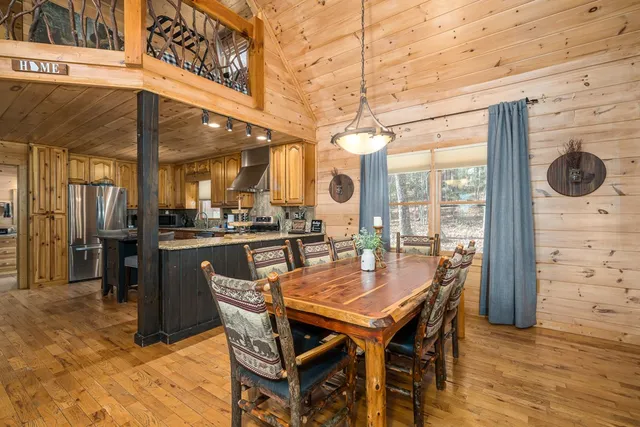 a kitchen with granite countertop kitchen island stainless steel appliances a refrigerator a sink a stove and cabinets