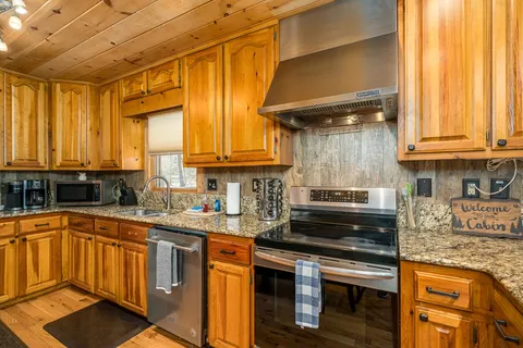 a view of a dining room with furniture a fireplace and wooden floor