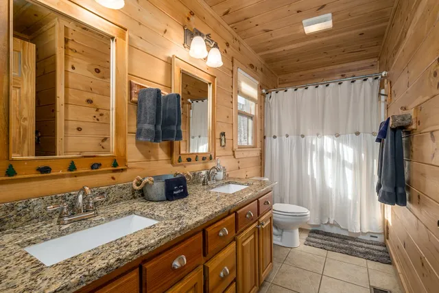 a bedroom with a bed and a table with wooden floor