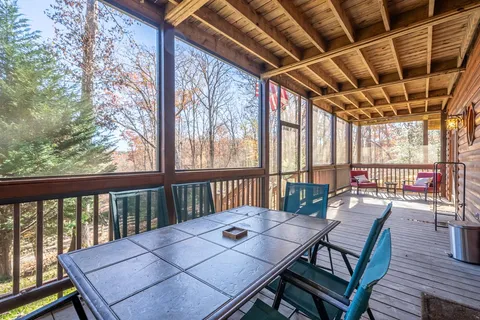 a bedroom with a large bed and a flat tv screen on dresser