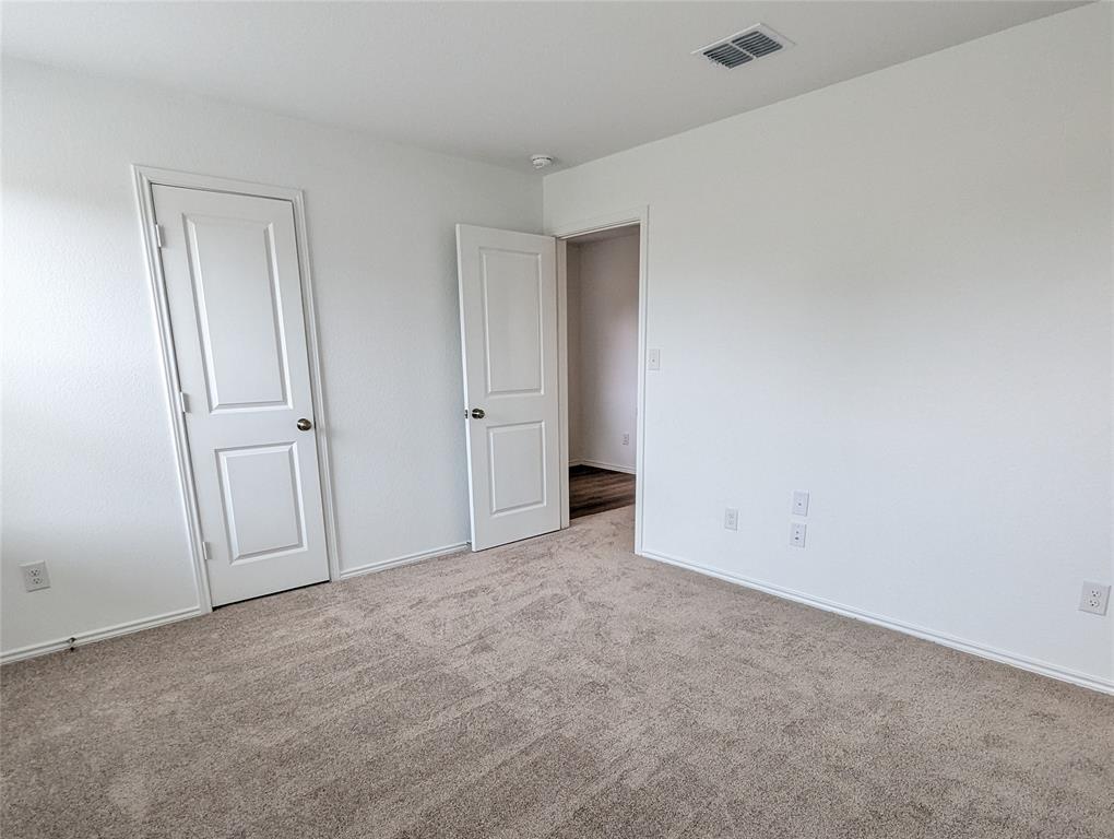 152 Avre Loop Kyle, TX 78640 - Photo 9 of 24 A well-maintained carpeted room offers versatile living possibilities.