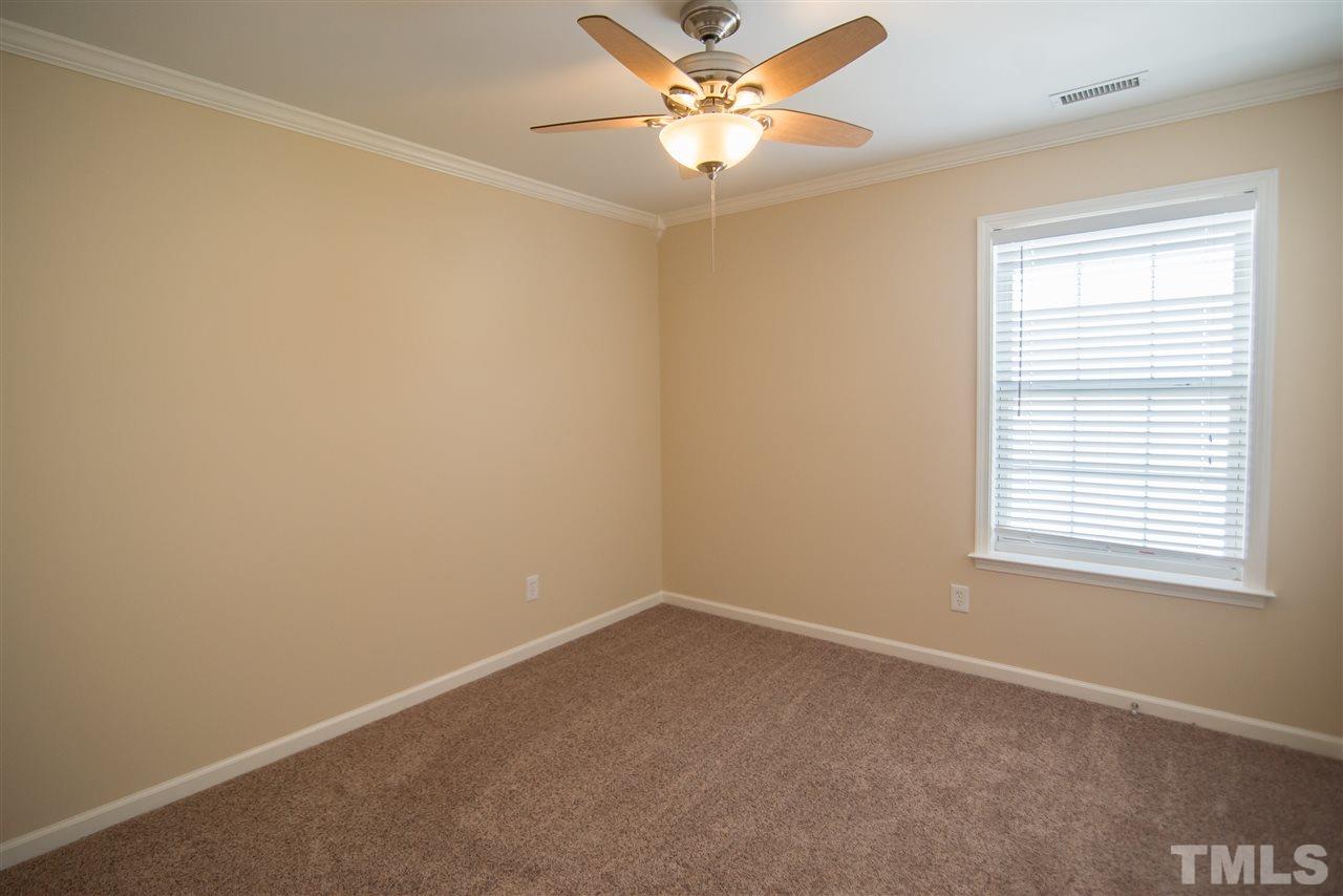 5525 Keowee Way Raleigh, NC 27616 - Photo 18 of 23 Large bedroom with plush carpet and ceiling fan.