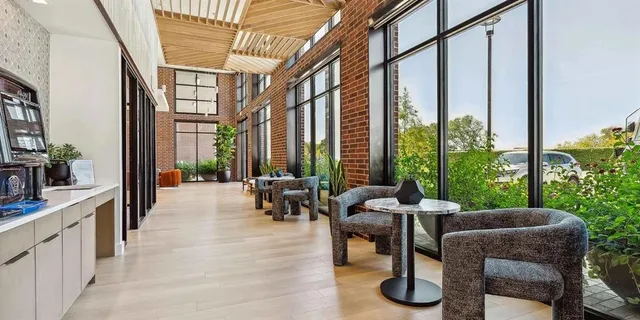 a building outdoor space with patio furniture and potted plants