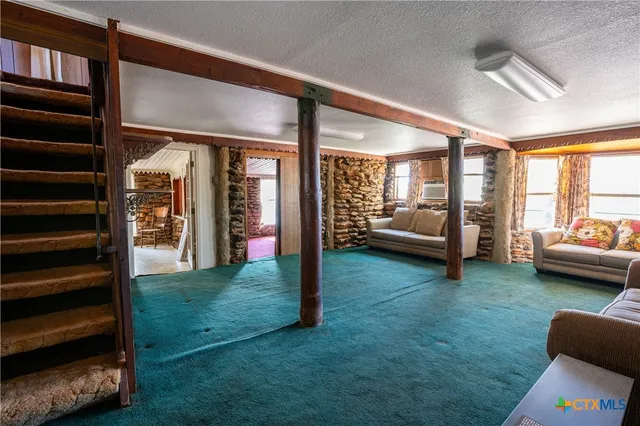 a view of a livingroom with furniture and windows