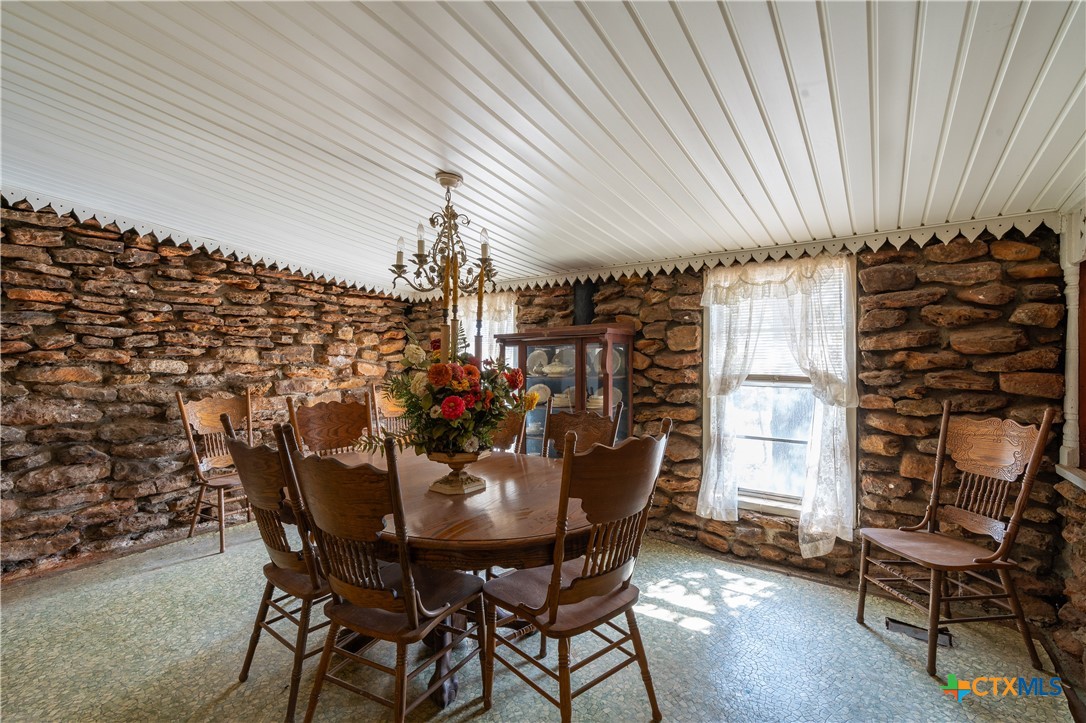 3779 Mule Creek Road Harwood, TX 78632 - Photo 12 of 40 a view of a dining room with furniture and chandelier