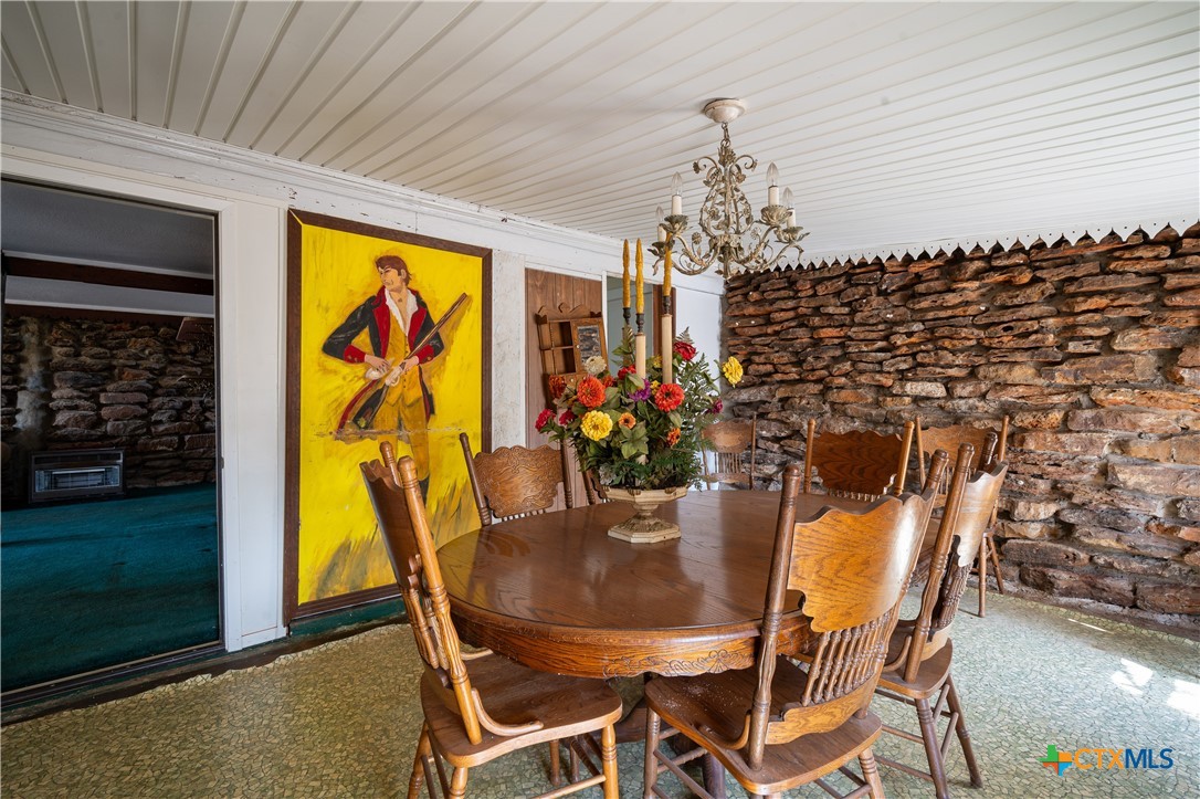 3779 Mule Creek Road Harwood, TX 78632 - Photo 13 of 40 a view of a dining room with furniture and chandelier