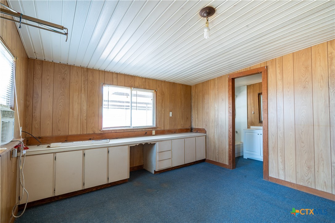 3779 Mule Creek Road Harwood, TX 78632 - Photo 17 of 40 a view of an empty room with window and cabinet
