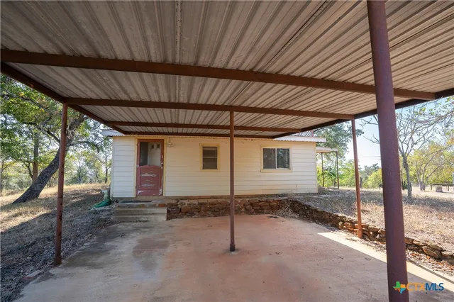 a tree in front of a white house