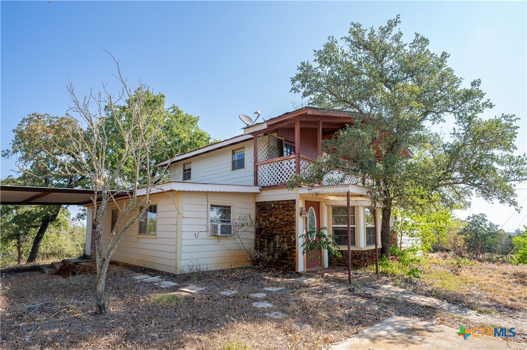 3779 Mule Creek Road Harwood, TX 78632 - Photo 8 of 40 a view of a house with a yard and large tree