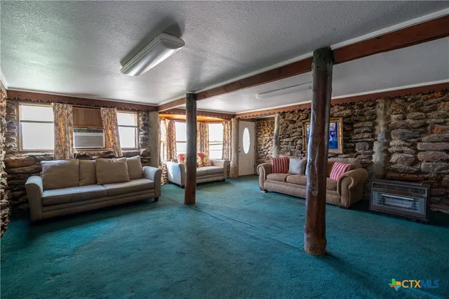 a living room with furniture and a floor to ceiling window